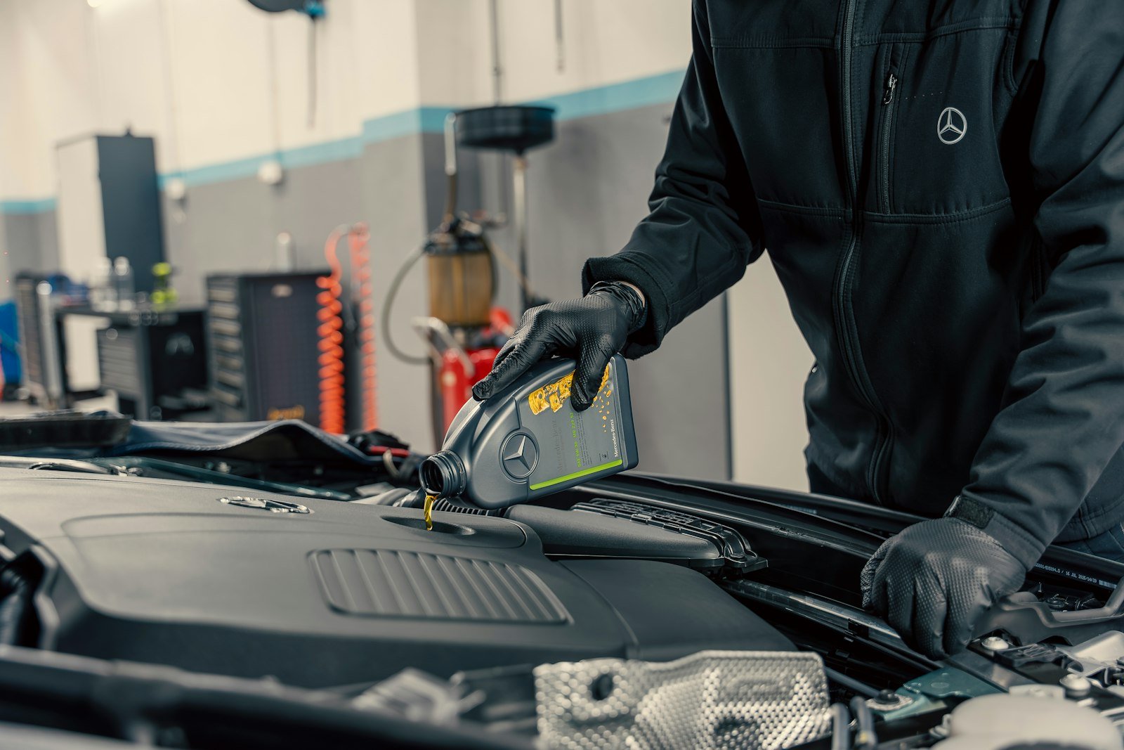 Mechanic pouring oil during an oil change in Fort Wayne